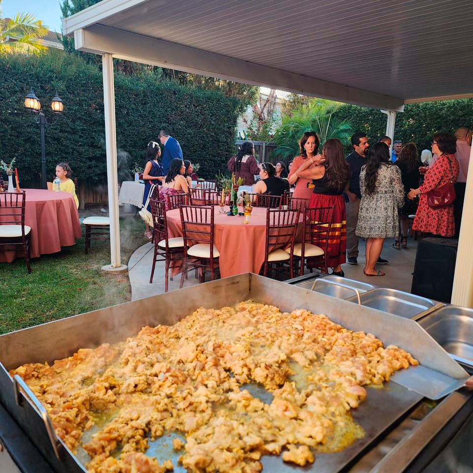 cozy-place Tacolab LA Mexican catering at a private event in Los Angeles. Fresh chicken being grilled for guests enjoying authentic tacos and Mexican street food.
