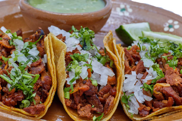 Tacolab LA authentic al pastor tacos for catering in Los Angeles. Fresh marinated pork tacos with pineapple, chopped onion, cilantro, and green salsa on corn tortillas.
