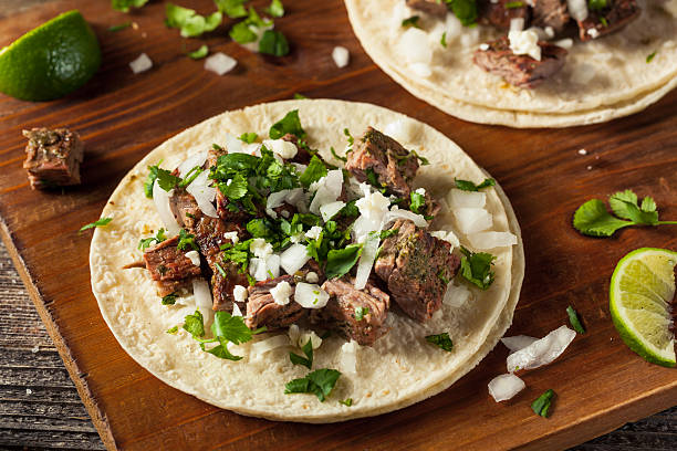 Tacolab LA authentic carne asada tacos for catering in Los Angeles. Grilled steak tacos with fresh chopped onion, cilantro, and lime on corn tortillas.