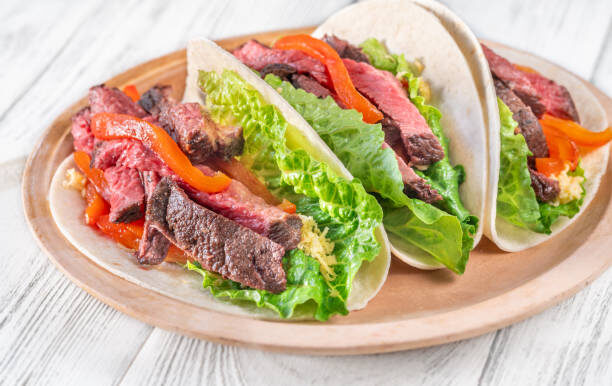 Tacolab LA steak fajita tacos with grilled peppers, onions and fresh lettuce for premium catering in Los Angeles.