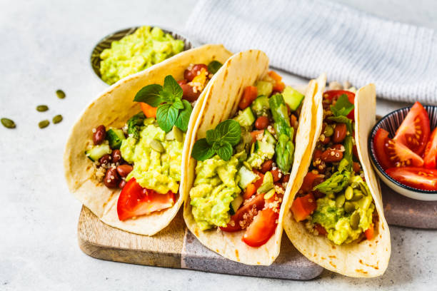 Tacolab LA fresh vegan tacos for catering in Los Angeles. Corn tortillas filled with guacamole, beans, tomatoes, cucumber, and seeds, a delicious plant-based option.